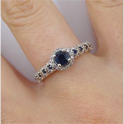 18ct white gold round sapphire and diamond cluster ring, with sapphire and diamond set shoulders, hallmarked, retailed by Emmy London, boxed with certificate