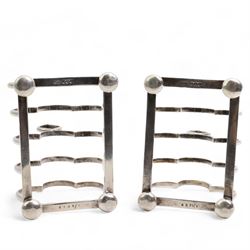 Pair of six division silver toast racks with Gothic loop handles on compressed bun feet, each L8cm Sheffield 1918/19 Maker James Dixon & Sons