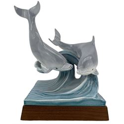 Tony Morris for Poole Pottery, leaping dolphin group, modelled over waves and mounted on a wooden base, H29cm. This model is a duplicate of a sculpture presented to Queen Elizabeth II and the Duke of Edinburgh on their visit to Poole Pottery in 1979, the original cast was destroyed after the production of the duplicate. Provenance: Arnold Smith, Chairman of Pool Potteries Collection