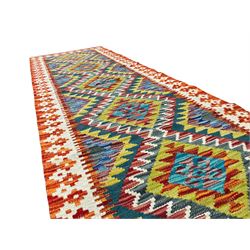Chobi Kilim multi-colour runner rug, the field with five lozenges with concentric bands in contrasting colours, the ivory and amber border with further geometric shapes