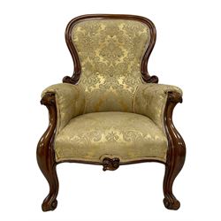 Victorian mahogany framed armchair, shaped and moulded frame carved with curled foliage, upholstered in pale gold floral pattern silk damask fabric, scrolled arm terminals on shaped moulded supports terminating to scroll carved feet