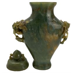 Chinese green hardstone vase and cover, the handles carved as flower heads and leaves H18cm