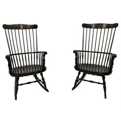 Pair of stained beech rocking chairs, shaped cresting rail over stick back, dished seat on turned supports united by turned stretchers and rockers 