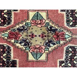 Kurdish rose ground runner rug, set with a series of ten floral medallions on linked field, the border decorated with stylised flower heads and bird motifs 