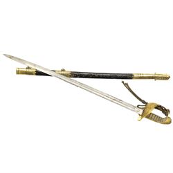 Victorian Naval officers sword by Wilson, King William St., London, the engraved blade with anchor and coat of arms, brass hilt with lion's head pommel and wire wound shagreen grip, blade length 75cm, brass and black leather scabbard