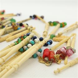 Collection of 19th century and later bone & plastic lace maker's bobbins, mostly with turned shafts, some with brass and metal wire work details, most with glass spangles (99 approx)