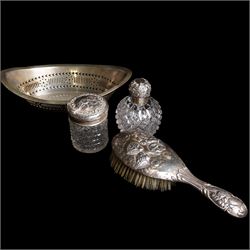 Silver navette shape bread basket with pierced sides, L28cm Chester 1900 Maker William Aitken, globe scent bottle with silver cover, glass dressing table jar with silver lid and a silver backed hairbrush 