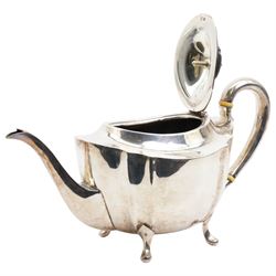 Silver oval teapot with ebonised lift, ivory insulators, loop handle and raised on four shaped supports and matching hot water jug Sheffield 1922/3 Maker Fenton Bros. Ltd. This item has been registered for sale under Section 10 of the APHA Ivory Act