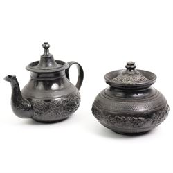 Early 19th century and later black basalt tea wares, mostly with relief or engine-turned bodies, including Cyples teapot, bachelors teapots, sucriers, jugs etc in one box