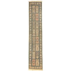 Fine Persian Kashmir ivory and pale indigo ground runner rug, the field decorated with sixteen rectangular panels depicting Mirab motifs and other traditional carpet designs, the border with repeating square panels of floral bouquets and foliate patterns