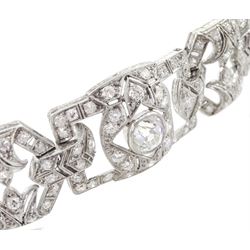 Continental Art Deco platinum milgrain set, old cut diamond openwork bracelet, circa 1920's, four rectangular shaped diamond panels each set with a principle diamond of approx 1.25 carat, 0.45 carat, 0.40 carat and 0.30 carat, the panels separated by chevron links and four leur de leys octagonal panels, total diamond weight approx 7.90 carat, makers mark IF, stamped 950, with shield hallmark, with insurance document, in original silk and velvet lined fitted box by G.Barichella, Nice-Vichy, France