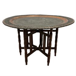 20th century Benares table, circular pierced copper tray top decorated with concentric floral pattern, on folding wooden base