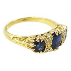 18ct gold three stone oval cut sapphire and four stone round brilliant cut diamond ring, stamped