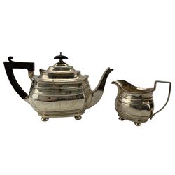 Silver rectangular teapot of panel sided design with ebonised handle and lift on compressed bun feet and the matching milk jug Birmingham 1916 Maker George Nathan and Ridley Hayes