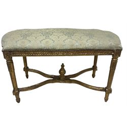 French Louis XIV design giltwood framed bench or window seat, sprung seat upholstered in pale blue foliate damask fabric with studwork border, raised on gesso moulded and carved tapering supports united by curved X-stretcher, with central acanthus carved finial