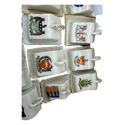 Collection of crested ware miniature cheese dishes and covers, including one by Goss, in one box