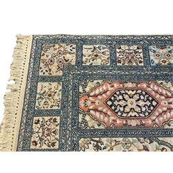 Fine Persian Kashmir ivory and pale indigo ground runner rug, the field decorated with sixteen rectangular panels depicting Mirab motifs and other traditional carpet designs, the border with repeating square panels of floral bouquets and foliate patterns