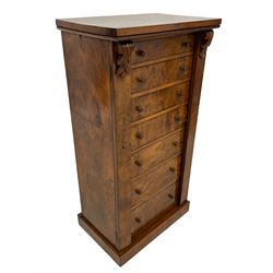 Victorian burr walnut Wellington chest, rectangular top with book-matched veneers, two hinged uprights with scrolled foliage carved brackets enclosing seven graduating drawers, on plinth base 