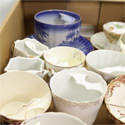 Victorian and later porcelain moustache cups, some with saucers, and related book, in one box