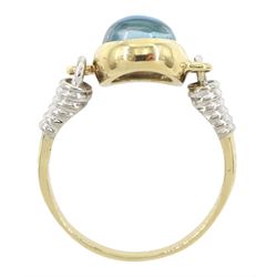 14ct gold blue topaz ring, oval cabochon blue topaz in a swivel setting two coiled shoulders, stamped