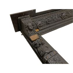 19th century Elizabethan design carved oak fire surround, reverse break-front lintel over egg and dart moulded upper edge, the ovolo-moulded frieze carved with scrolling leafy branches, central cartouche and putti riding dolphins, the uprights carved with female masks over carved busts, square tapering pilasters carved with ribbon tie over trailing fruit, on stepped moulded base 