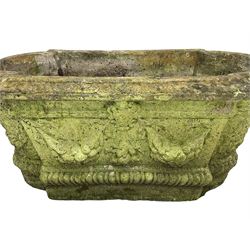 Pair of cast stone garden planters, rectangular form with stepped rounded ends, foliate moulded rim, the body decorated with floral and fruit festoons over gadrooned moulding