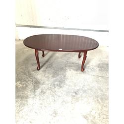 Cross banded hardwood oval coffee table on shaped supports L106cm